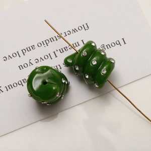 Detailed macro view of dark green spiral beads with sparkling rhinestones for DIY jewelry
