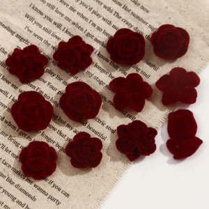 Macro detail of dark red flocked velvet rose and camellia floral DIY jewelry parts