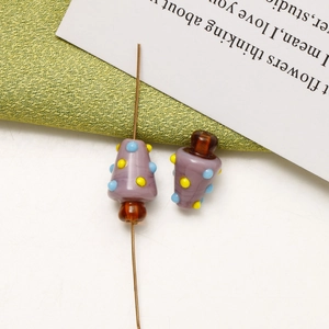 Macro shot of handmade Christmas glass beads with colorful polka dots for DIY jewelry