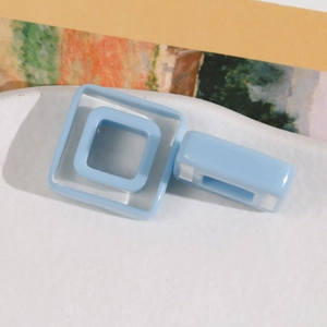 Macro shot of light blue resin geometric square hollow parts for DIY hair accessories