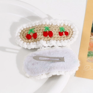 Detailed front and back view of hand-knitted cherry pattern hair clips with metal BB clips