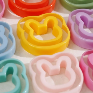 Close-up of colorful resin rabbit charms for DIY jewelry making and hair accessories