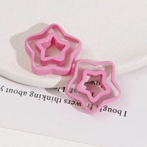Detail view of pink double-layer resin star charms for DIY earring and hair accessory making