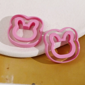 Close-up of pink rabbit resin charms for DIY earring and hair accessory crafting