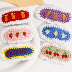 Set of six handmade crochet hair clips featuring cute strawberry cherry and carrot patterns