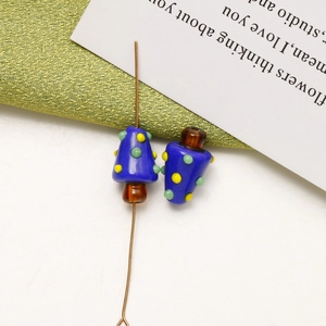 Macro shot of colorful mushroom glass beads for DIY jewelry making with blue and green texture