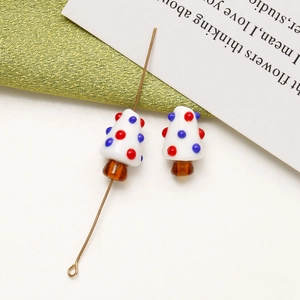 Macro shot of handmade mushroom glass beads with colorful dots for DIY jewelry making