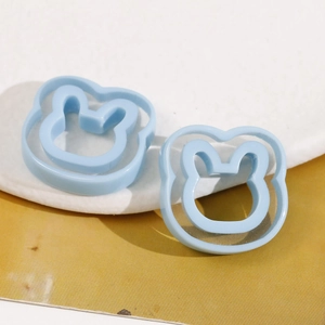 Macro shot of light blue resin rabbit head charms for DIY jewelry and hair accessories