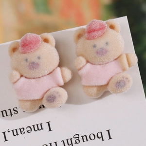 Close-up of cute flocked miniature bears in pink hats for DIY jewelry and hair accessories