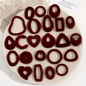 Flat lay of diverse burgundy flocked geometric pendants for DIY jewelry earring making