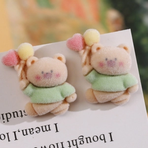 Macro view of cute flocked teddy bear resin charms for DIY hair accessories and earrings
