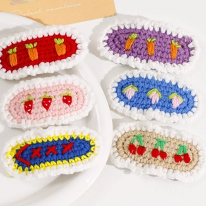 Handmade crochet hair clips set featuring strawberry and cherry knit patterns