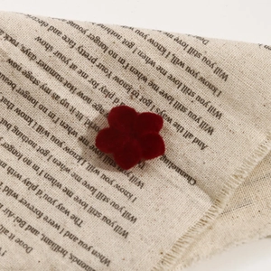 Close-up of vintage red velvet camellia flower resin charms for DIY jewelry making