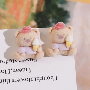 Close-up of cute flocked resin bear charms wearing pink hats for DIY crafts and jewelry