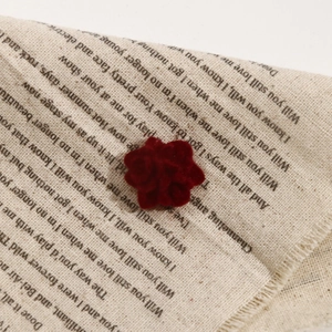 Macro view of velvet-flocked deep red rose resin cabochon for DIY jewelry making