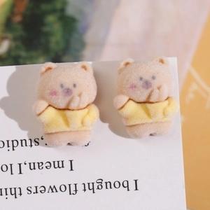 Macro shot of cute flocked brown bear charms with soft fur texture for DIY craft jewelry