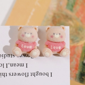 Close-up of cute flocked bear charms with Love sweater for DIY jewelry making
