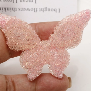 Macro shot of large pink butterfly resin accessory with glittery textured beads