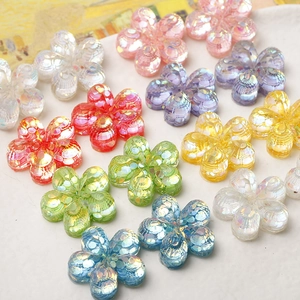 Macro view of colorful resin five-petal flower charms with glitter sequins for DIY crafts