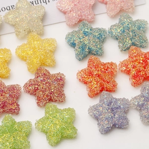 Close-up of 20mm colorful resin star charms with glittery sugar sand texture for DIY crafts