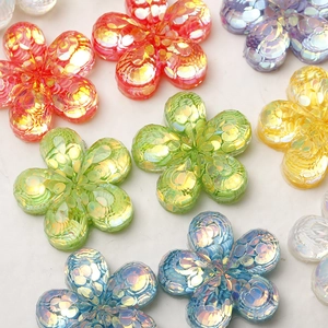 Close-up of colorful resin flower charms with iridescent sequins for DIY jewelry making