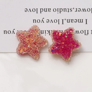 Detail of 20mm candy-colored star resin patches with glitter sequins for DIY crafts
