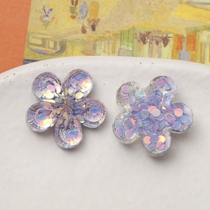 Macro shot of iridescent resin flower charms for DIY jewelry and hair accessories