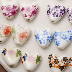Hand-painted heart-shaped ceramic beads with floral patterns for DIY jewelry making