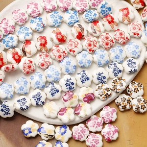 Detailed view of colorful plum blossom ceramic beads with floral patterns for jewelry making