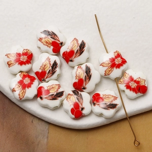 Hand-painted ceramic flower beads with red floral patterns for DIY jewelry making