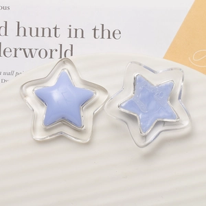 Close-up of double-layered purple star resin accessories on a white striped display plate