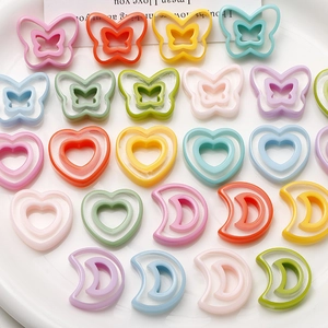 Macro view of macaron resin charms in butterfly, heart and moon shapes for DIY jewelry