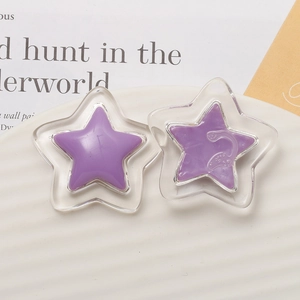 Transparent resin star charms for DIY hair clips and crafts in a decorative ceramic bowl
