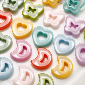 Close-up of colorful heart and butterfly resin charms for DIY jewelry making sets