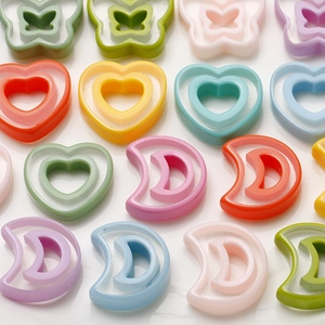 Colorful semi-transparent resin charms in heart, butterfly, and moon shapes for DIY jewelry