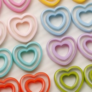 Macro detail of colorful hollow heart resin charms for DIY jewelry making and crafts