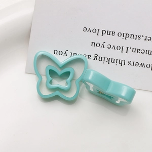 Close-up of sky blue double-layered hollow butterfly resin charm for DIY jewelry making