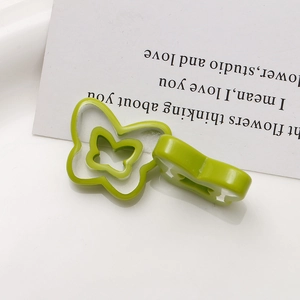 Detail of light green butterfly resin accessories with double-layer hollow design for DIY crafts