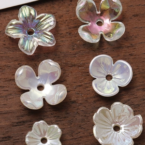 Detailed macro view of colorful gradient acrylic flower charms with AB iridescent coating