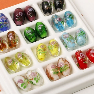 Macro view of multi-colored oval glass floral beads with gold foil for DIY jewelry making