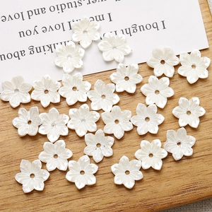 Macro shot of pearl white six-petal resin flower beads with center holes for DIY crafts