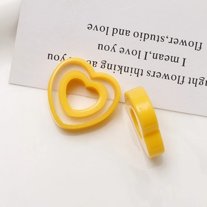Macro detail of yellow resin heart rings showing smooth finish and material thickness