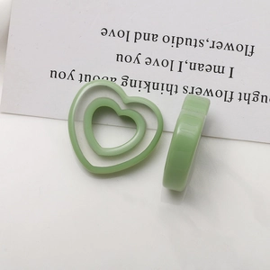 Detail of light green double-layered hollow heart resin charm for DIY jewelry accessories
