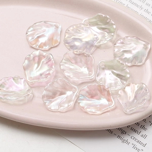 Close-up of translucent iridescent camellia flower charms for DIY jewelry making