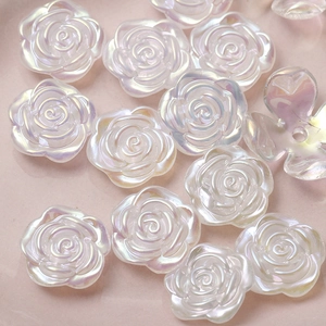 Macro shot of iridescent aurora white camellia acrylic charms for DIY hair accessories
