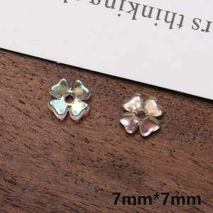 Macro view of 7mm iridescent aurora clover charms for DIY jewelry making and accessories