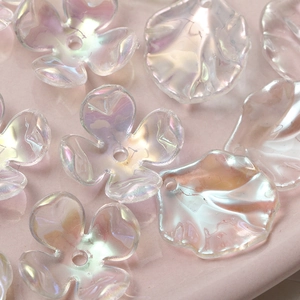 Macro shot of iridescent acrylic camellia flower charms with DIY pre-drilled holes