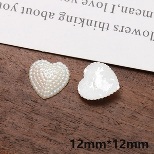 Macro shot of 12mm iridescent pearl white heart acrylic charms for DIY crafts and jewelry