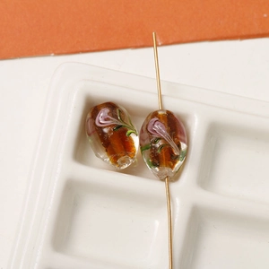 Detailed macro of amber glass beads with floral pattern for DIY jewelry making