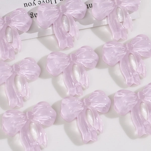 Macro detail of lavender translucent resin bows with textured finish for DIY crafts